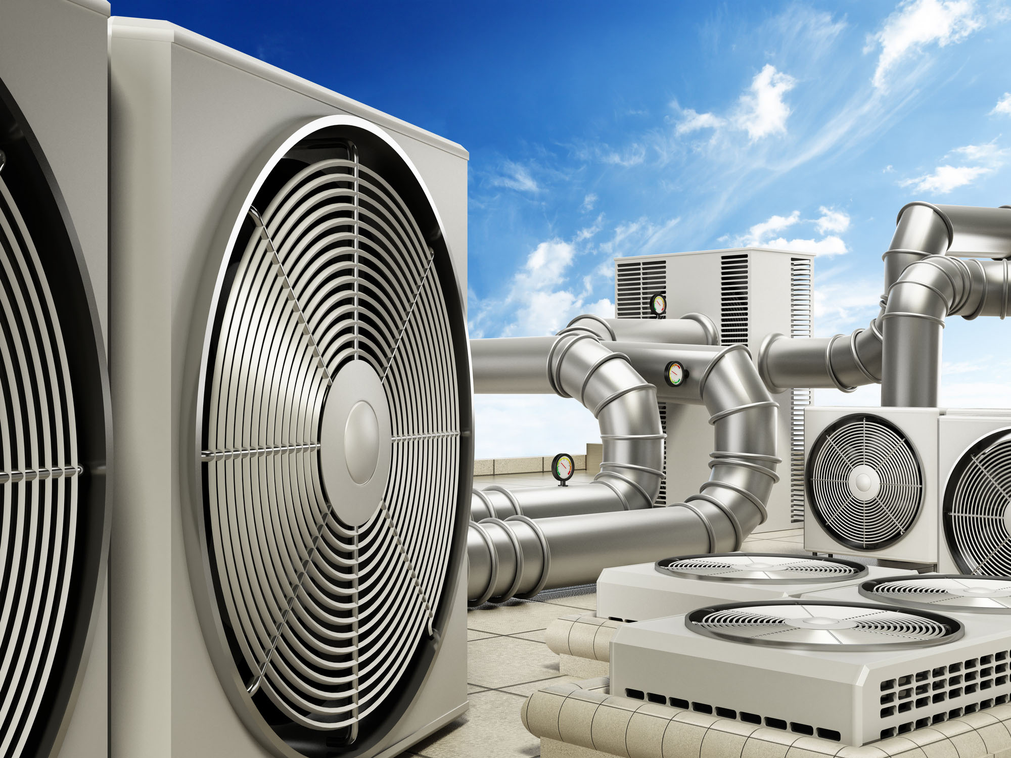 Air conditioning system with air conditioners, ventilators and pipes on top of a building.