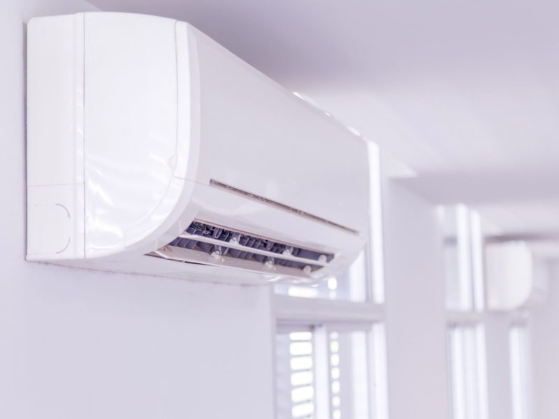 Split system air conditioner mounted on wall in side the room