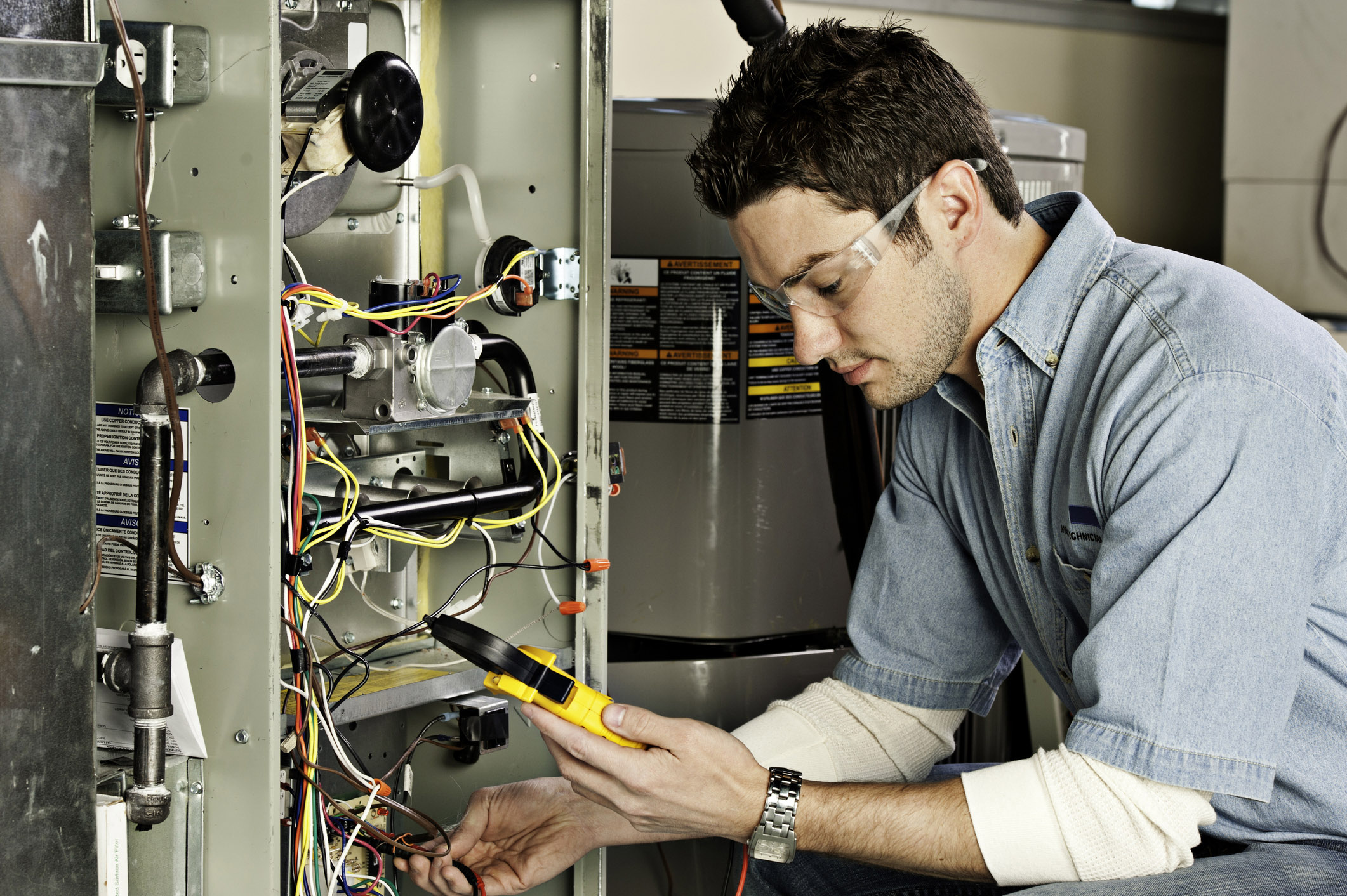 HVAC technician testing a home furnace