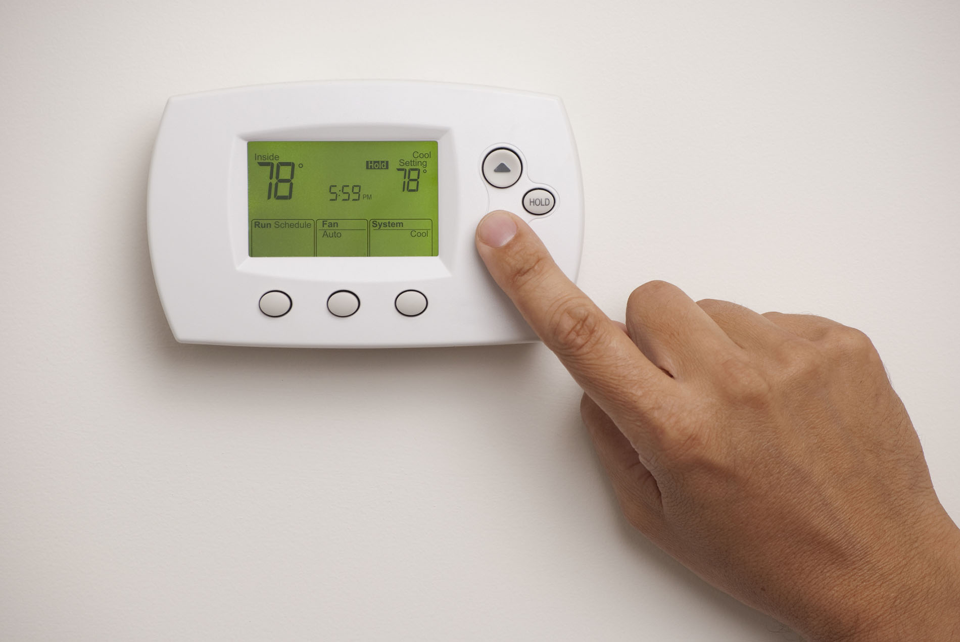 Male hand on Digital Thermostat